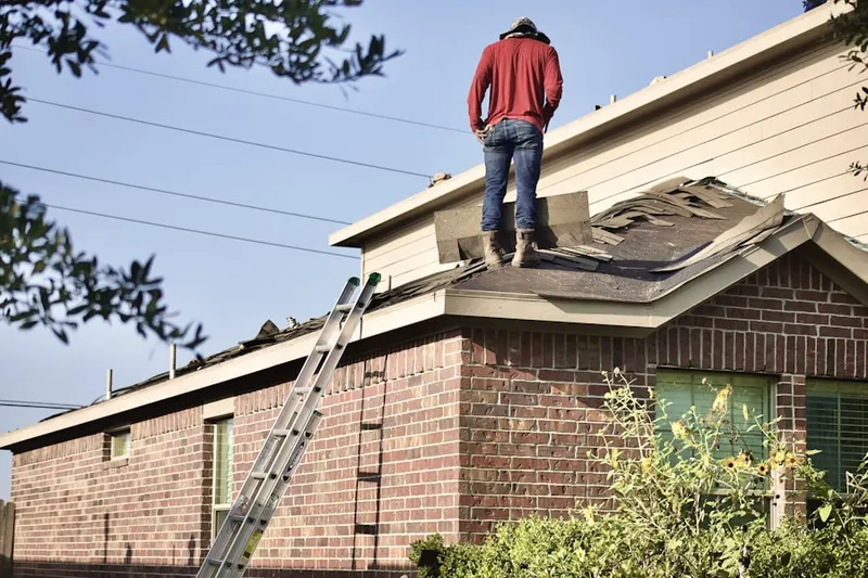Professional roofer working on a residential roof in Sunwest Trails